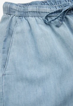 Byxa i denim med vida ben