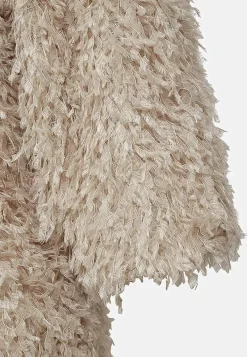 Festtopp med fjäderliknande material