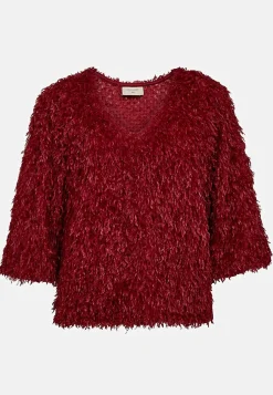 Festtopp med fjäderliknande material